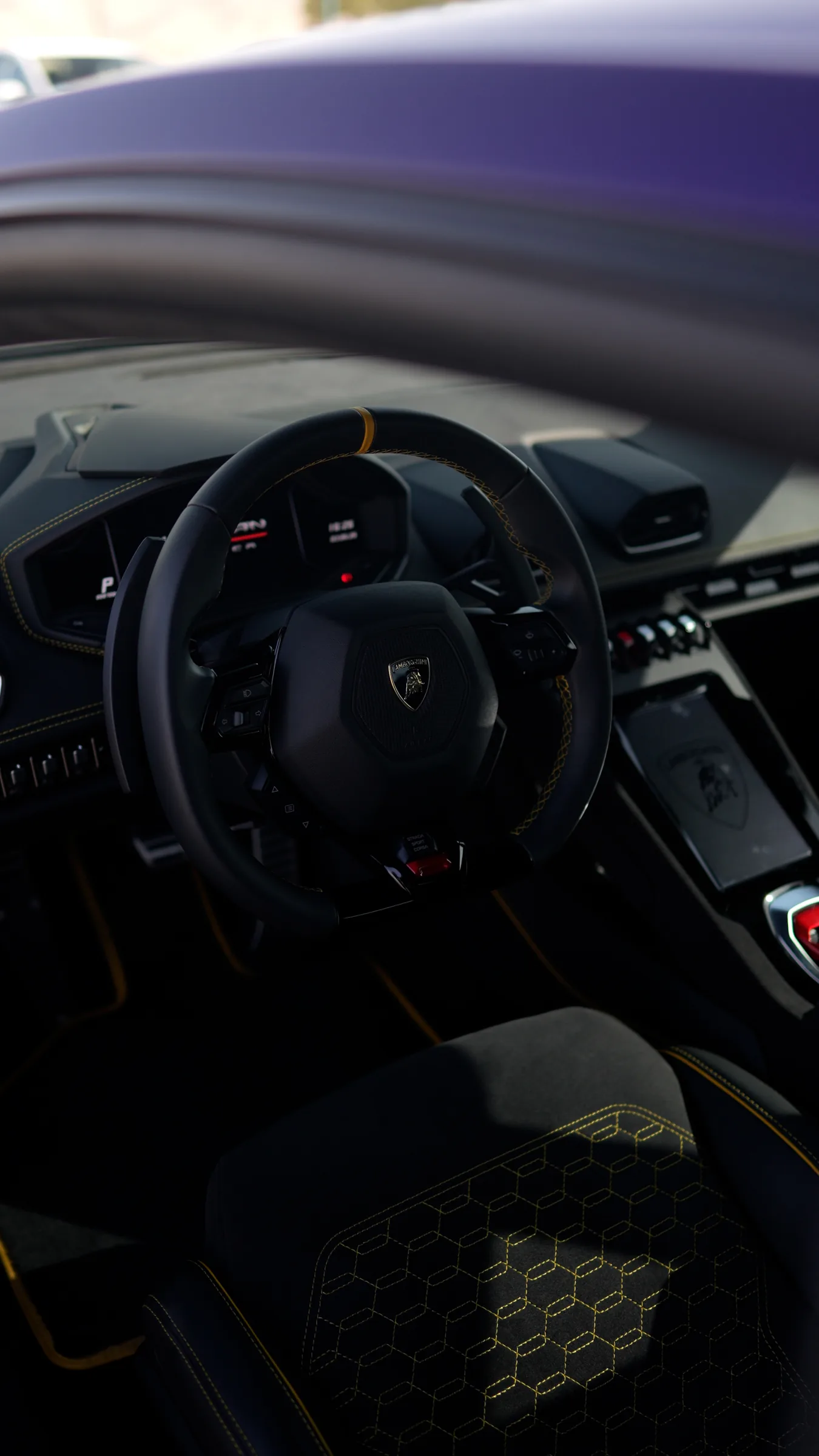 Lamborghini Huracán dashboard detail with yellow contrast stitching