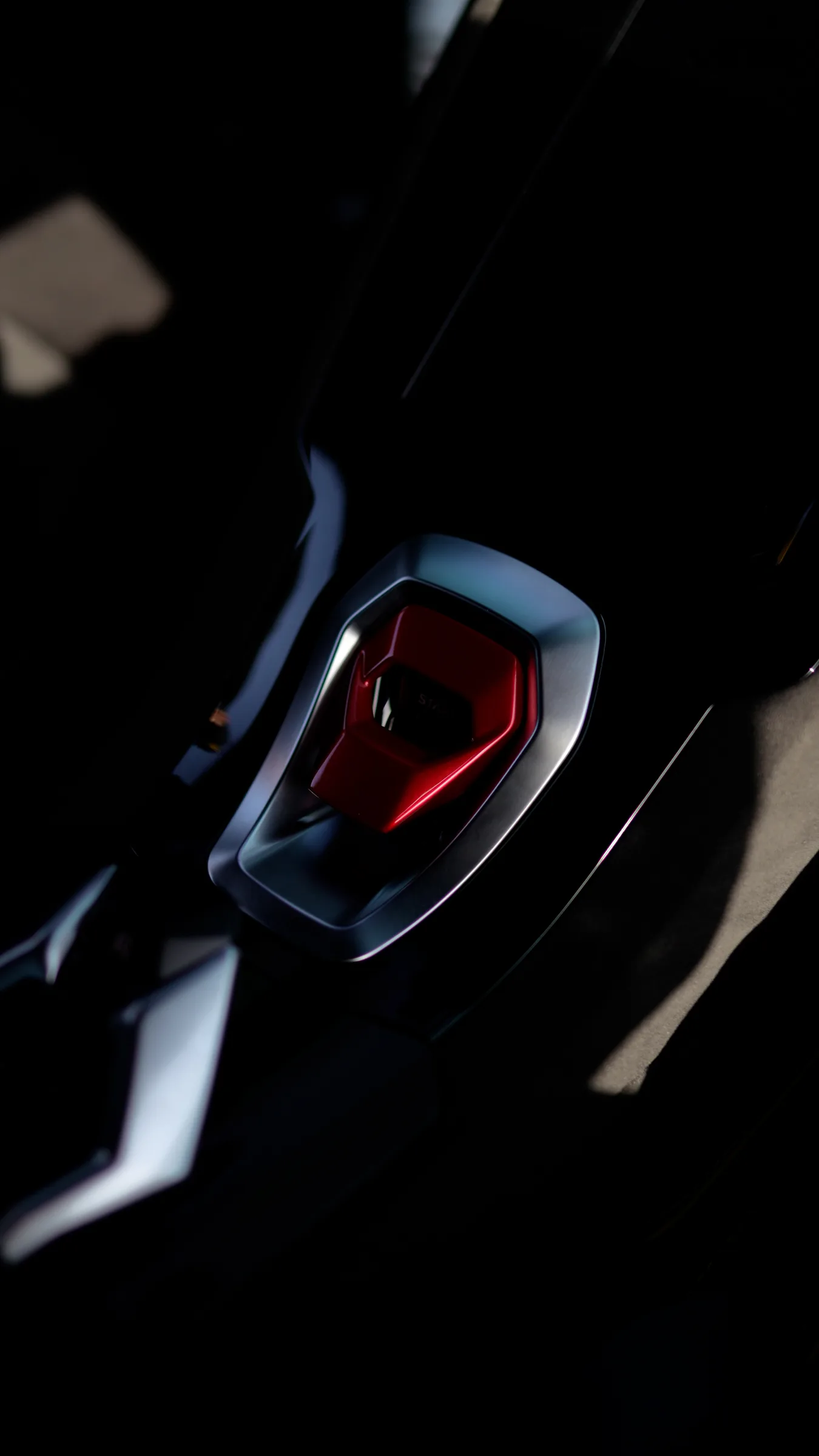 Red engine start-stop button inside Lamborghini Huracán