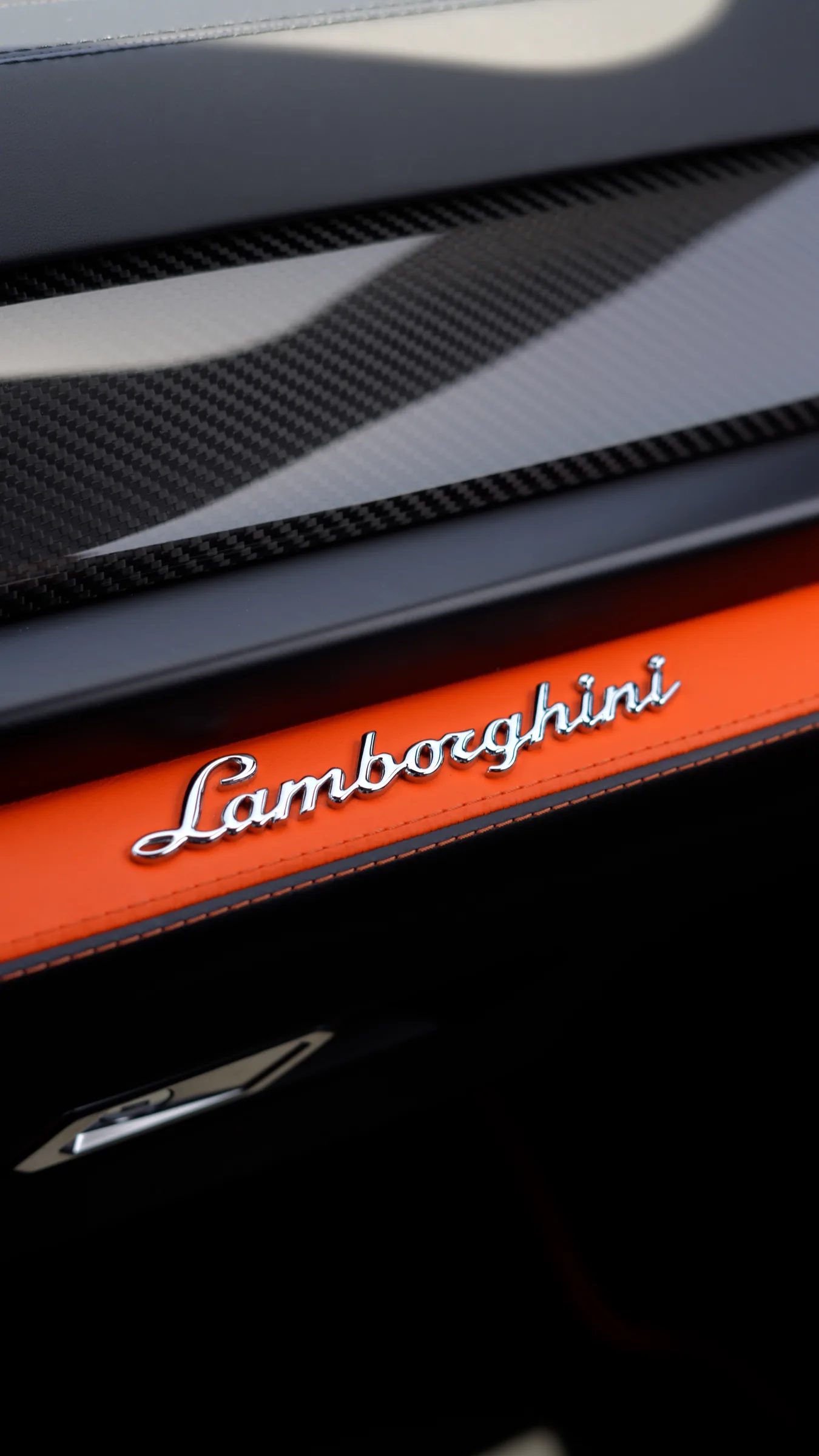 Lamborghini script badge detail on Urus interior trim