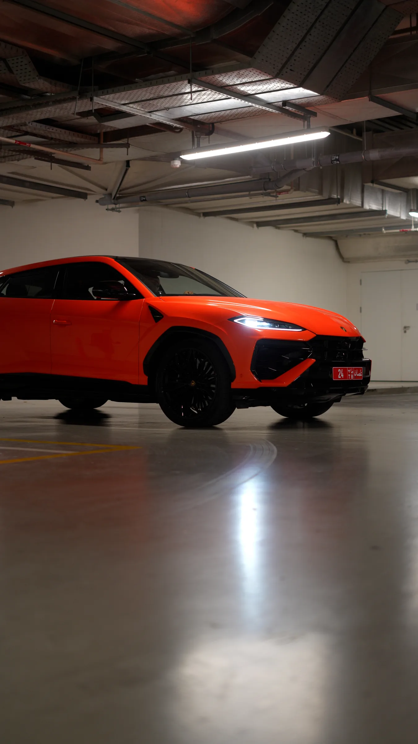 Lamborghini Urus rear quarter view with Oman number plate in a garage